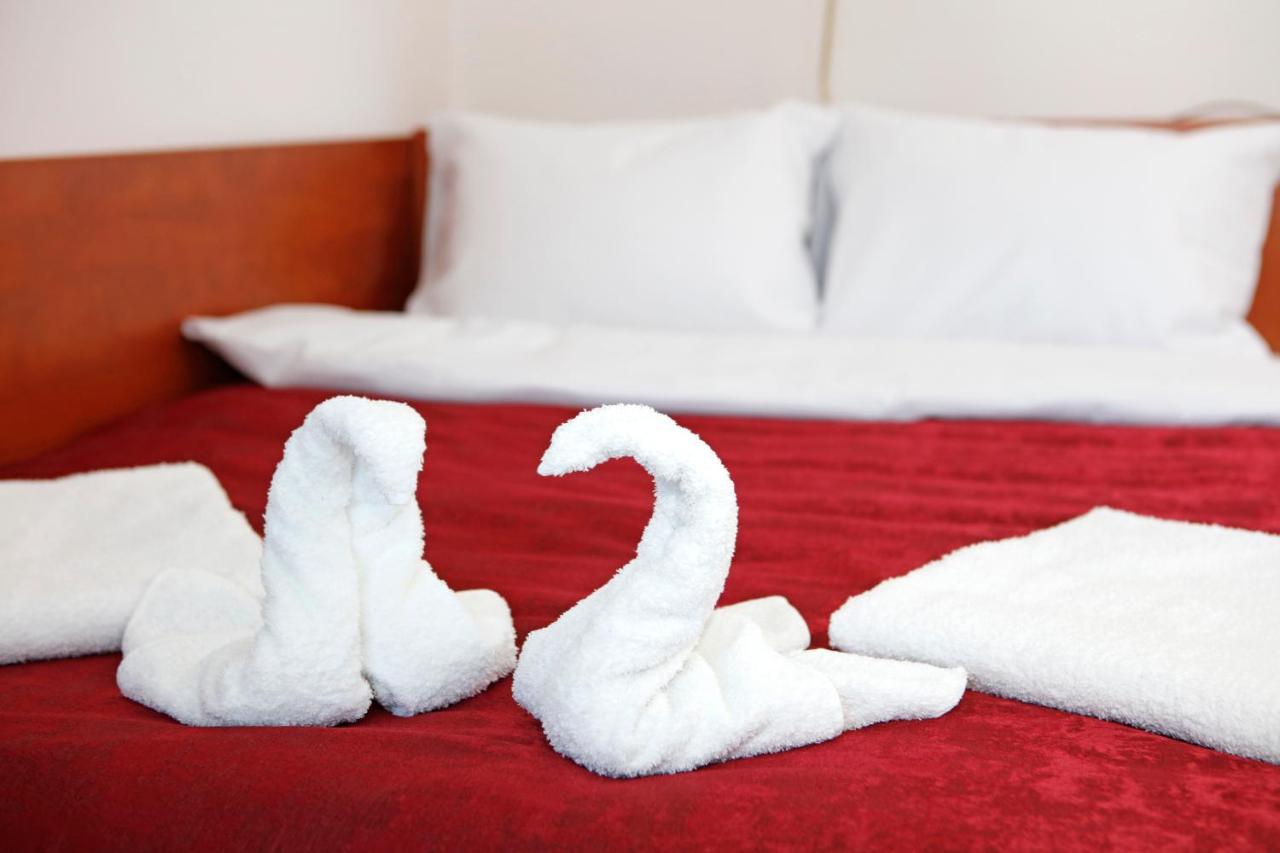 Towel swans on the bed, made up for guests