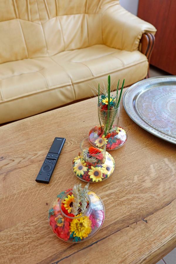 The living-room table, with vases of dried flowers